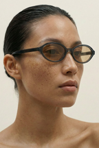 Person wearing BLUE eyeglasses against a neutral background